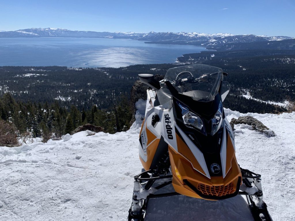 Snowmobile on a cliff overlooking Lake Tahoe 