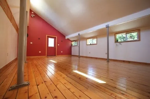 Empty room with wood floor and tall ceilings at the wellness center
