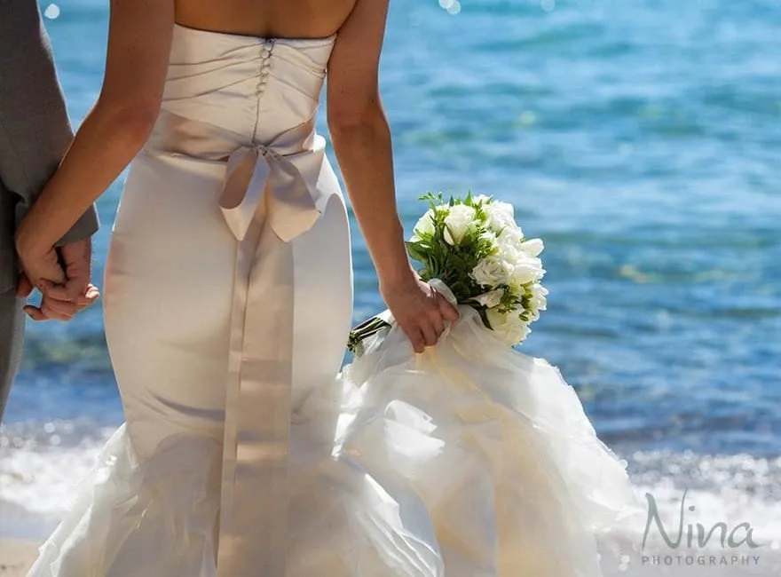 Bride holding her bouquet next to Lake Tahoe