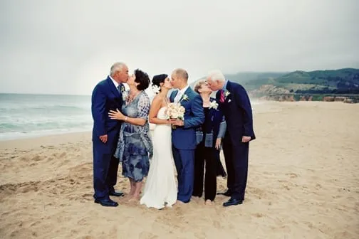 Wedding party on the beach of the Lake Tahoe kissing