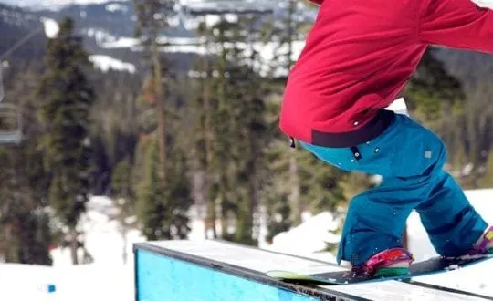 Snowboard doing a backside tail slide at Sugar Bowl Terrain Park