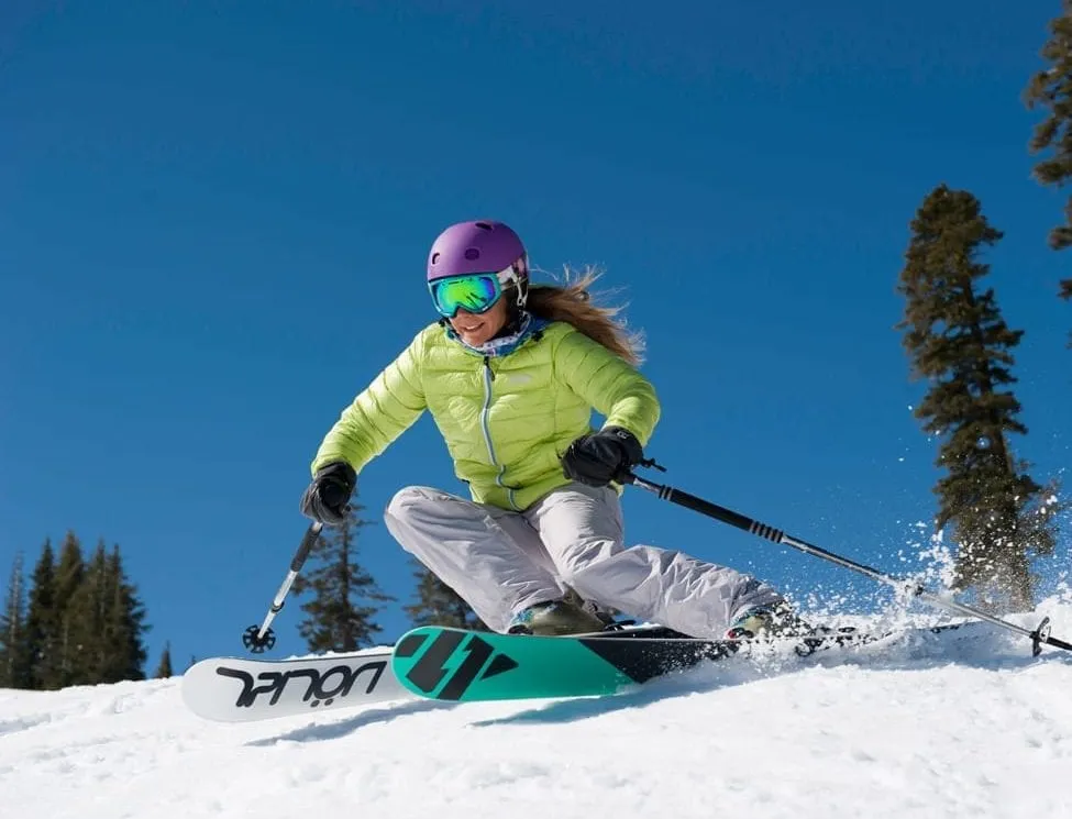 Person in Lime green jacket shredding the slopes