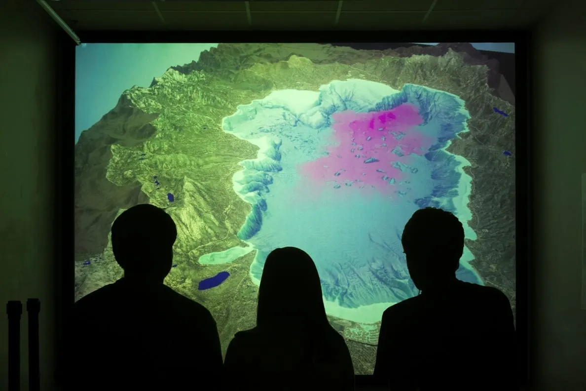 People looking at a lightbox map of Lake Tahoe