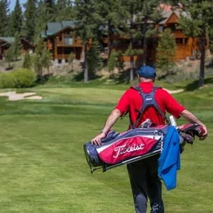Man walking with his golf clubs on the golf course