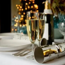 Champagne glass and bottle on a table during Christmas