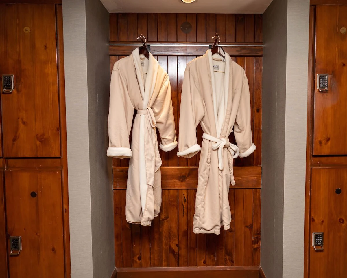 2 robes hanging in a closet at the spa