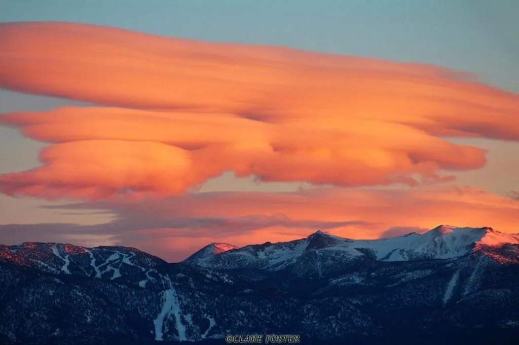 Big orange clouds over snowy mountain peaks in Lake Tahoe 