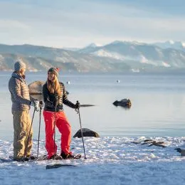 Man and woman snowshoeing in Lake Tahoe during winter