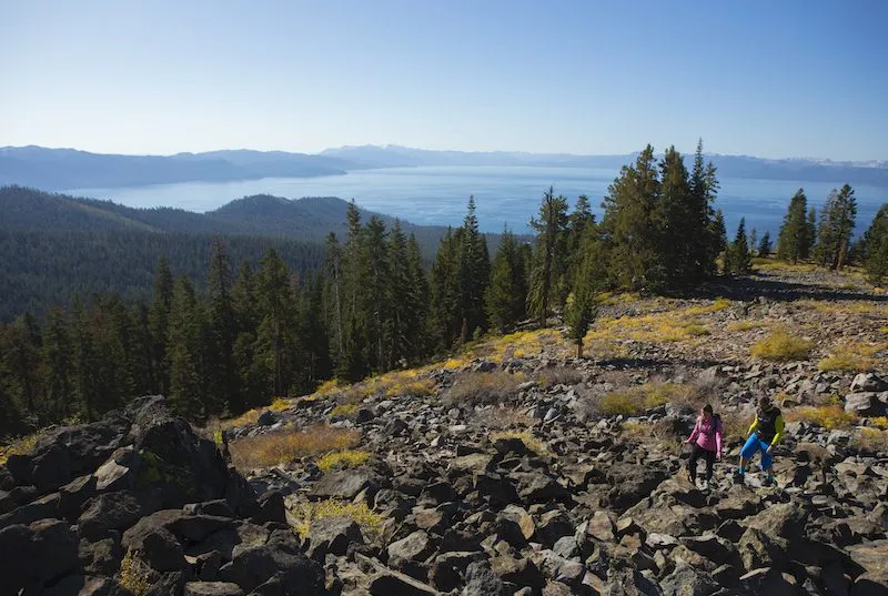 Couple hiking in a scenic viewpoint in lake Tahoe 