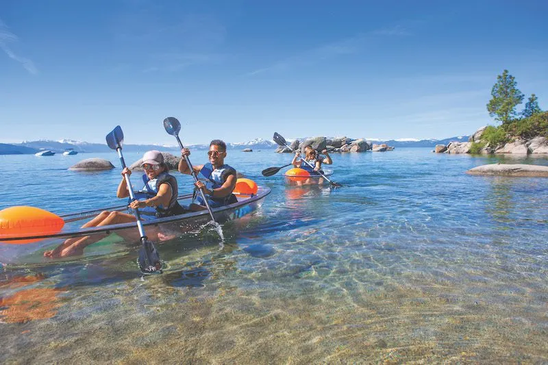 Group kayaking on Lake Tahoe on clear kayaks