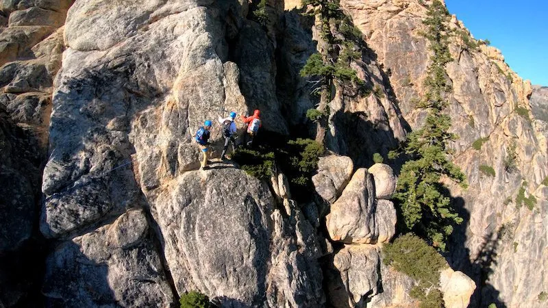 Three people rock climbing in lake Tahoe