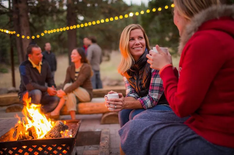 Folks enjoying a fire pit and warm drinks in Lake Tahoe 