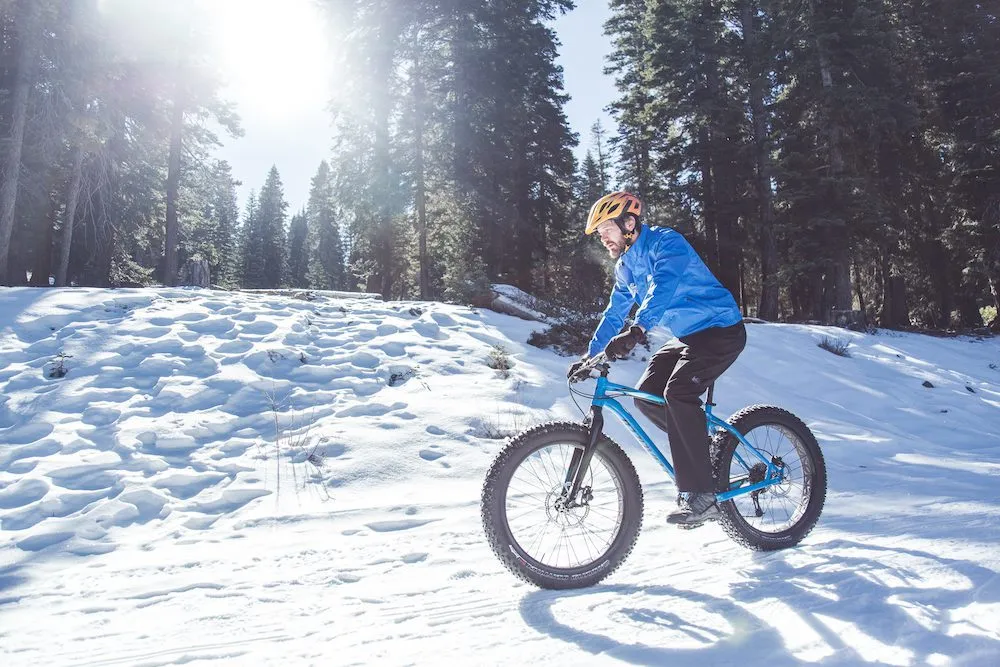 Man riding mountain bike on a snowy trail in Lake Tahoe 