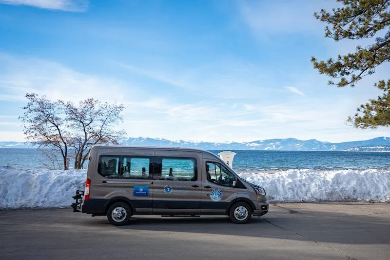 TART van next to a snowbank on the shores of Lake Tahoe 