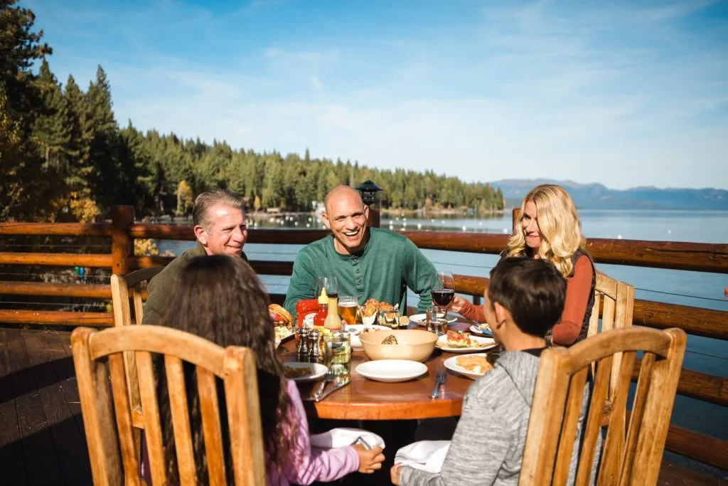 Family enjoying a nice meal on a patio overlooking Lake Tahoe