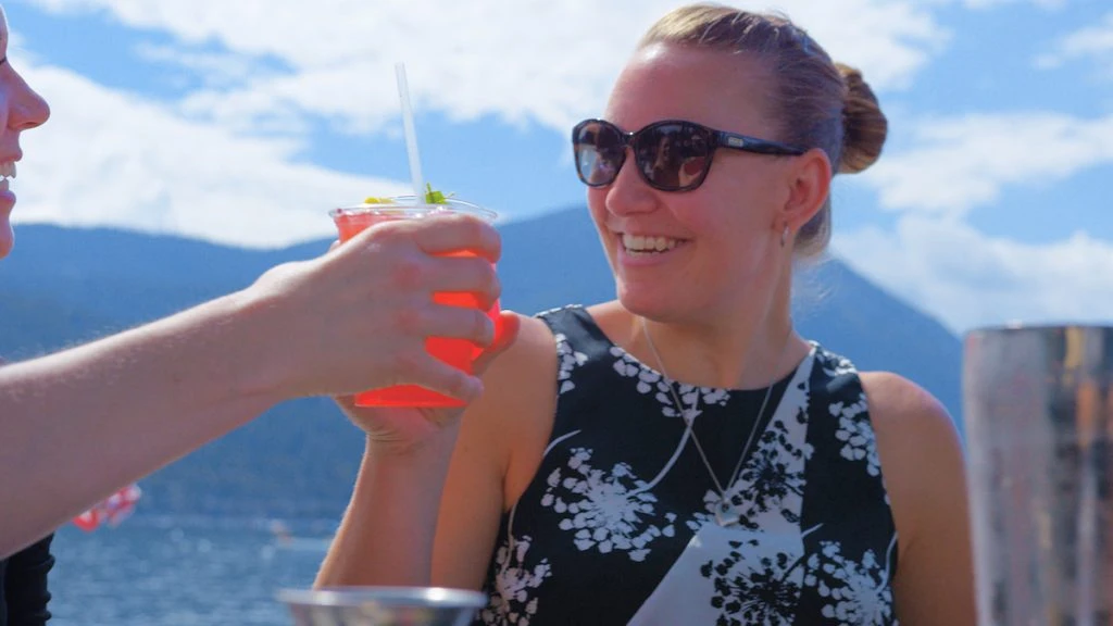 Lady enjoys her cocktail lakeside in Lake Tahoe 