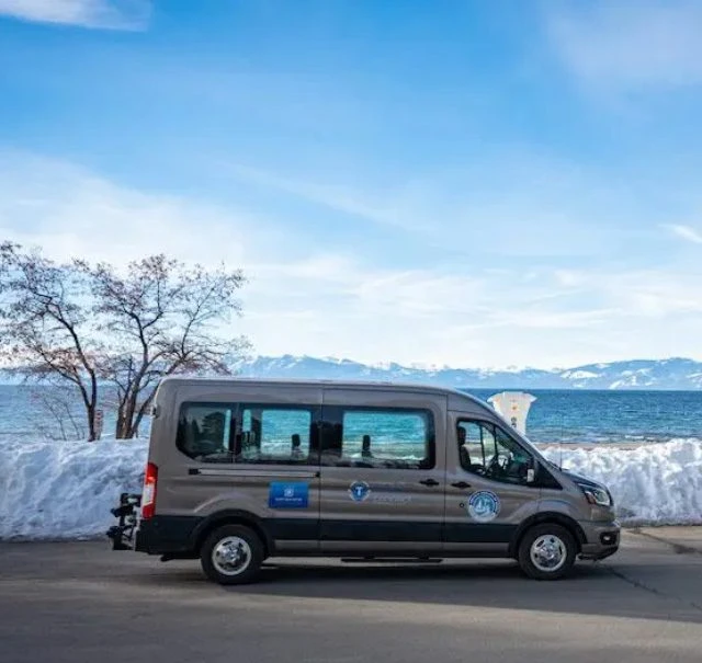 TART Connect van driving by Lake Tahoe and snow covered ground