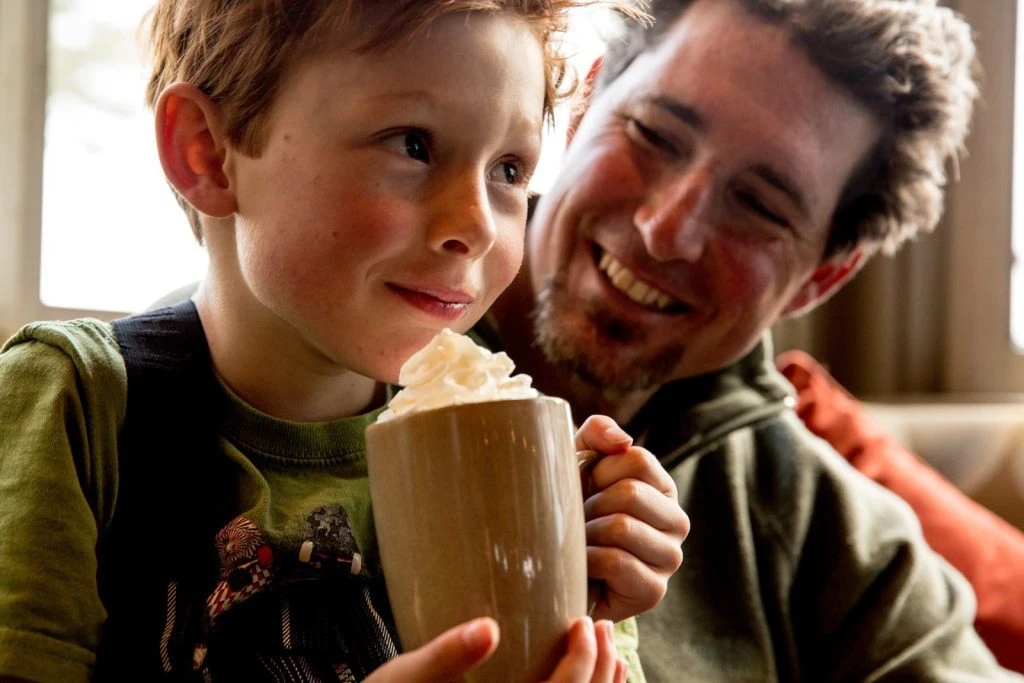 Father and sone enjoy a hot cocoa