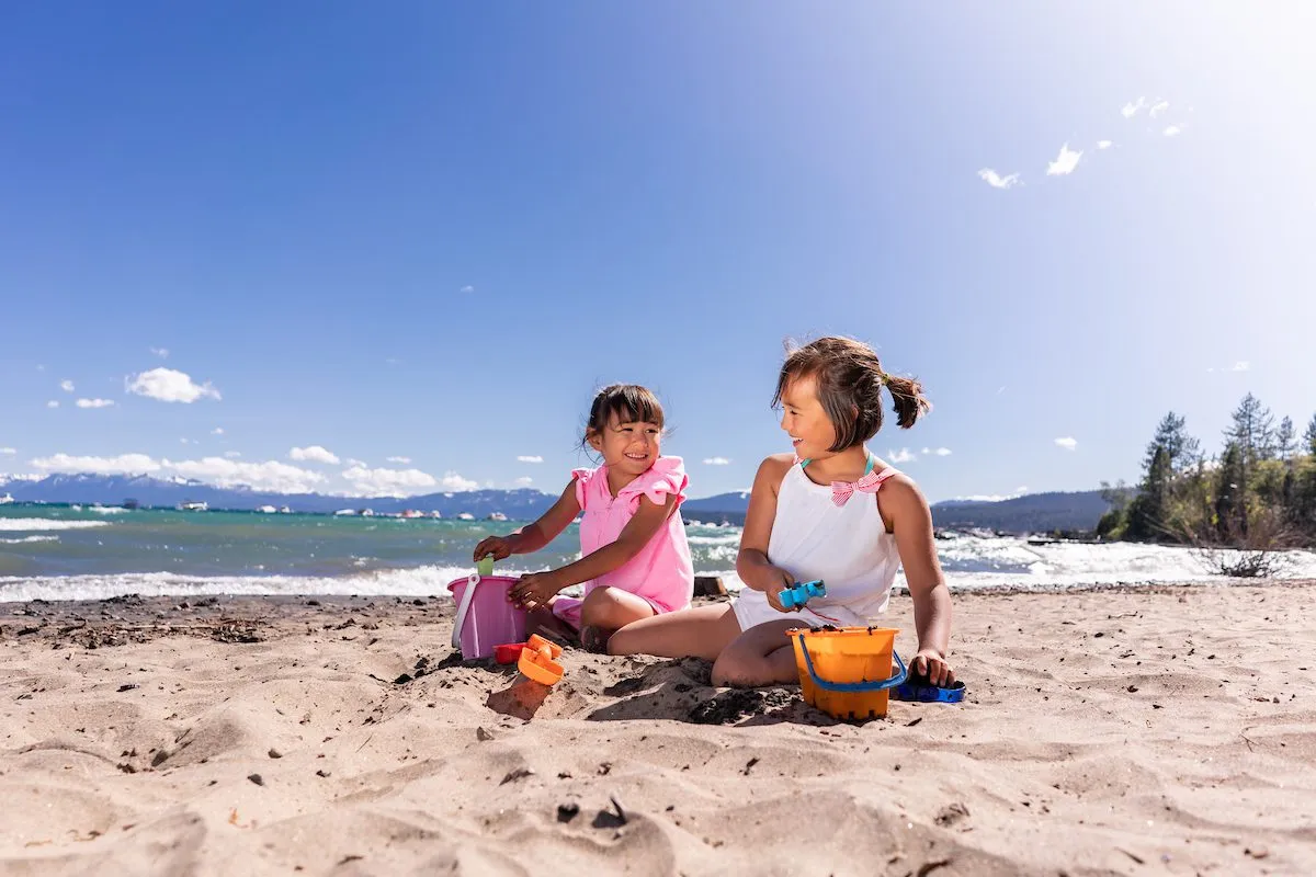 Two kids playing on the shore of the Lake Tahoe Beaches
