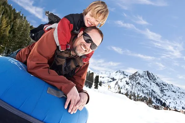 Father and son snow tubing in Lake Tahoe