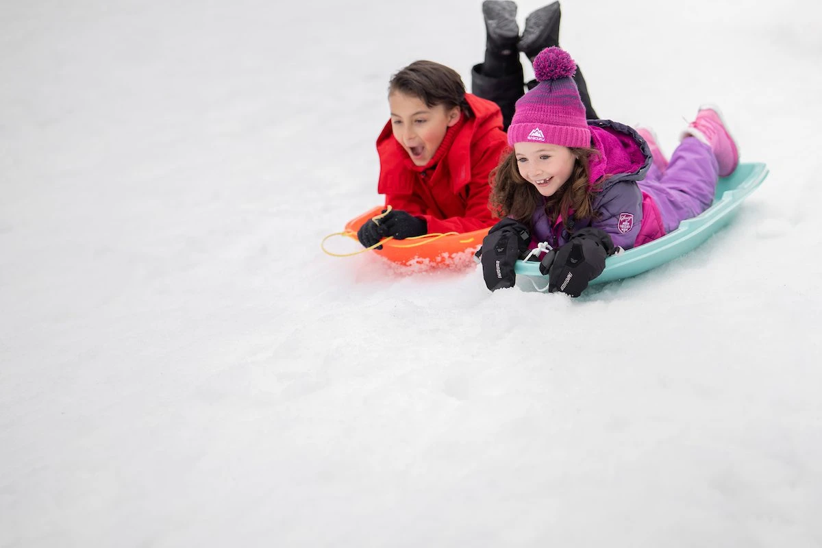 Brother and sister sledding in Lake Tahoe