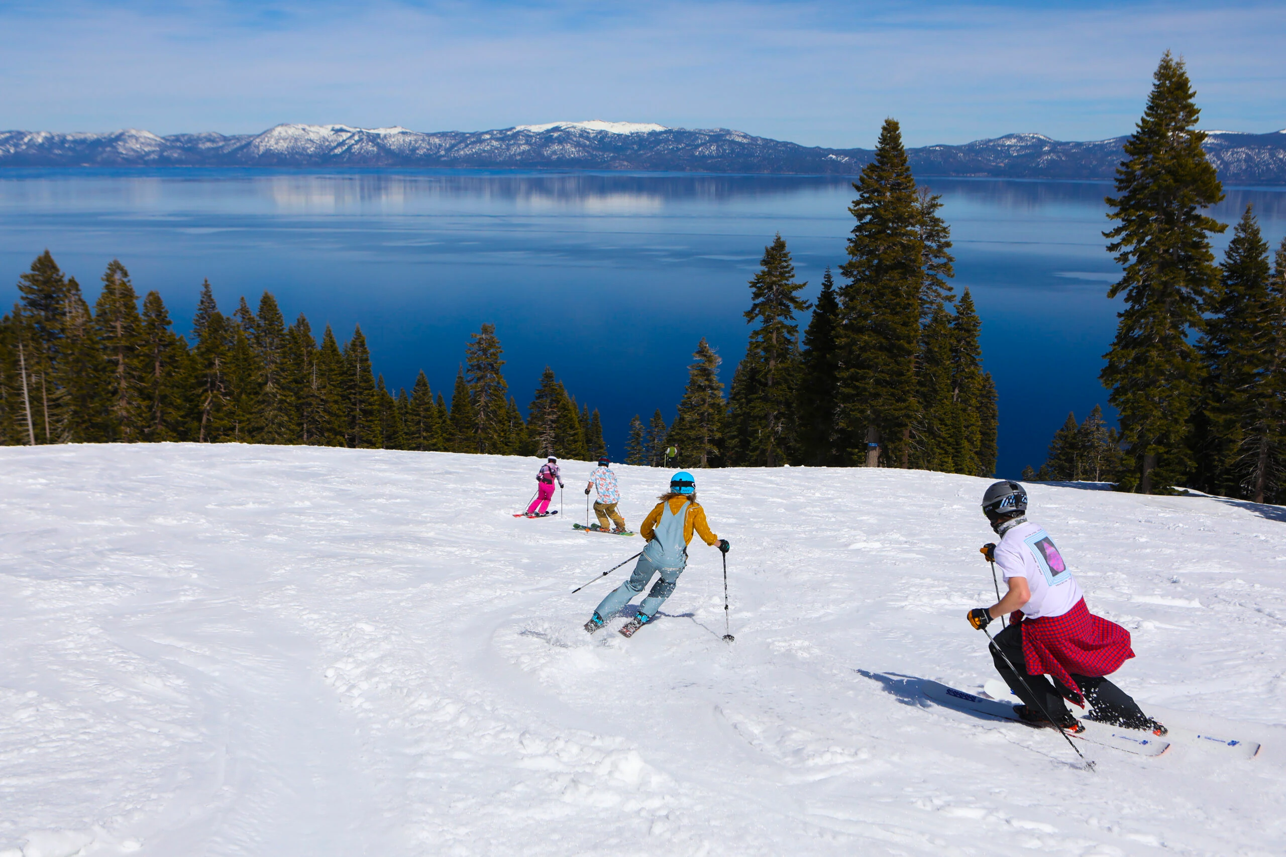 Family skiing down the sunny slopes of Lake Tahoe