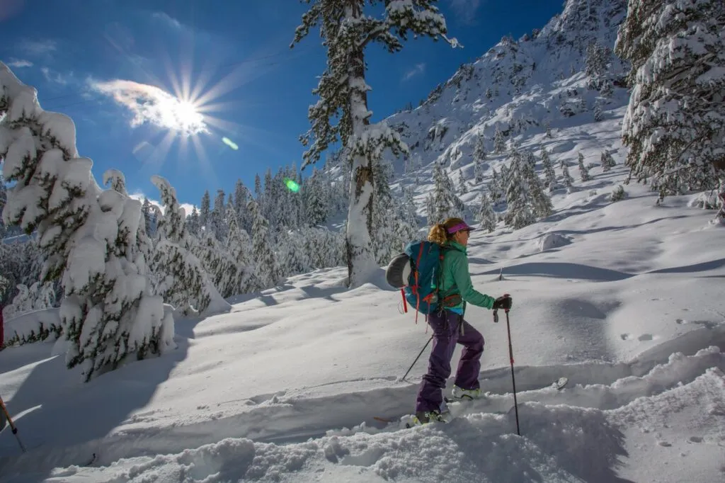 Snowshoeing and skiing in Lake Tahoe among snow covered trees and mountains