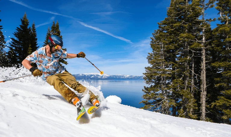 Family skiing together on a snowy slope overlooking North Lake Tahoe