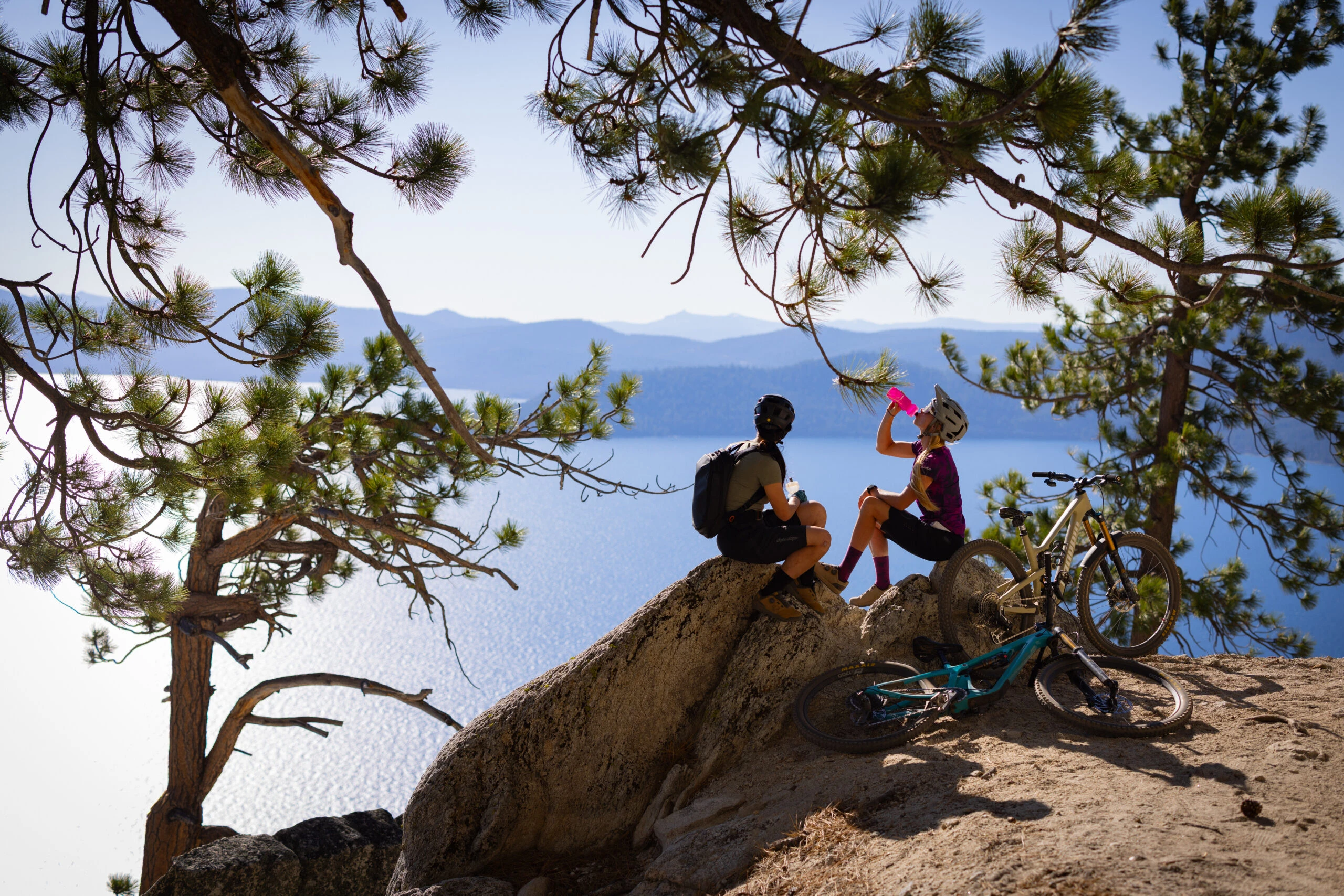 Two Mountain bikers stopping for a break at a viewpoint in Lake Tahoe